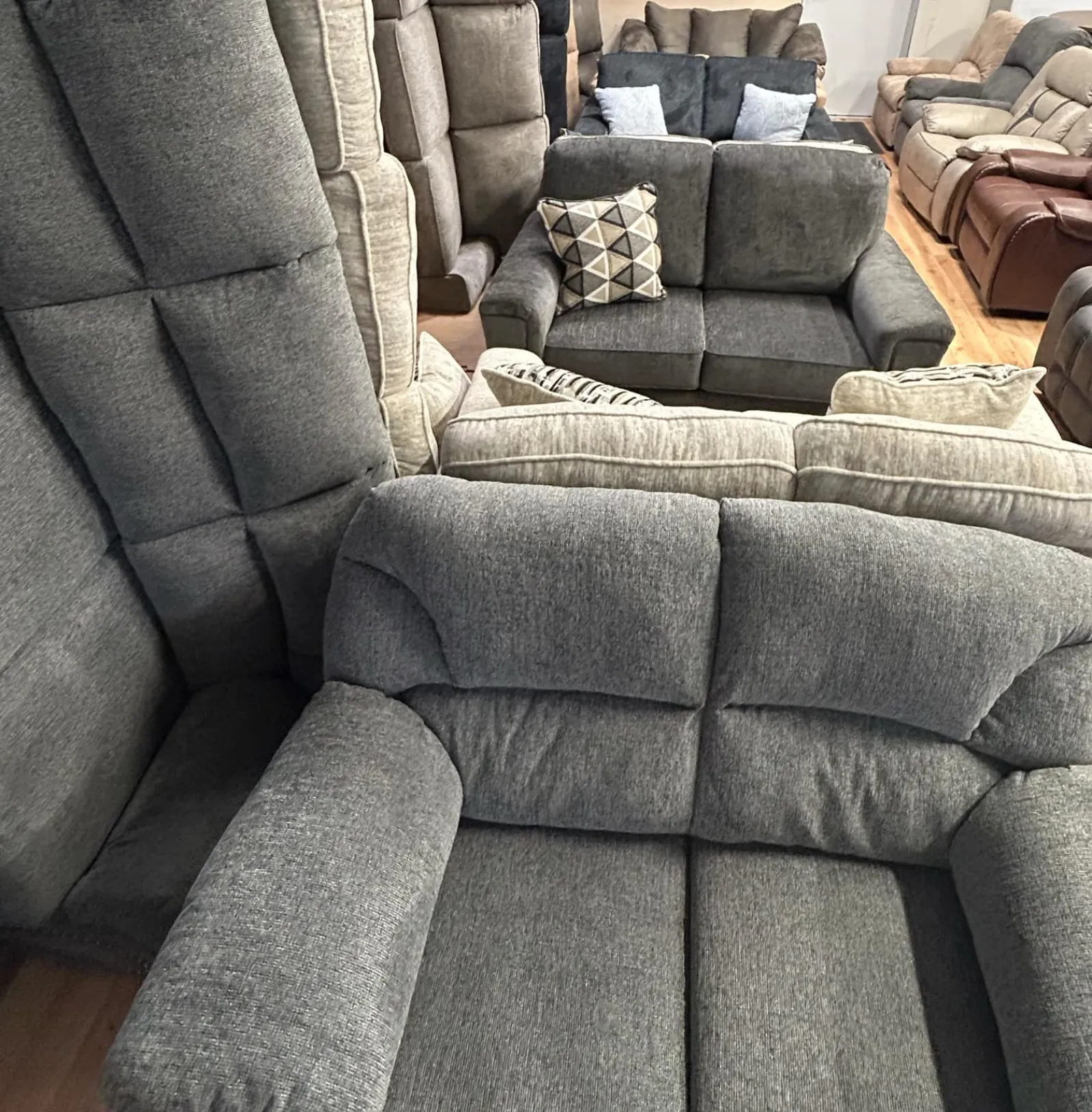 a grey couch with pillows