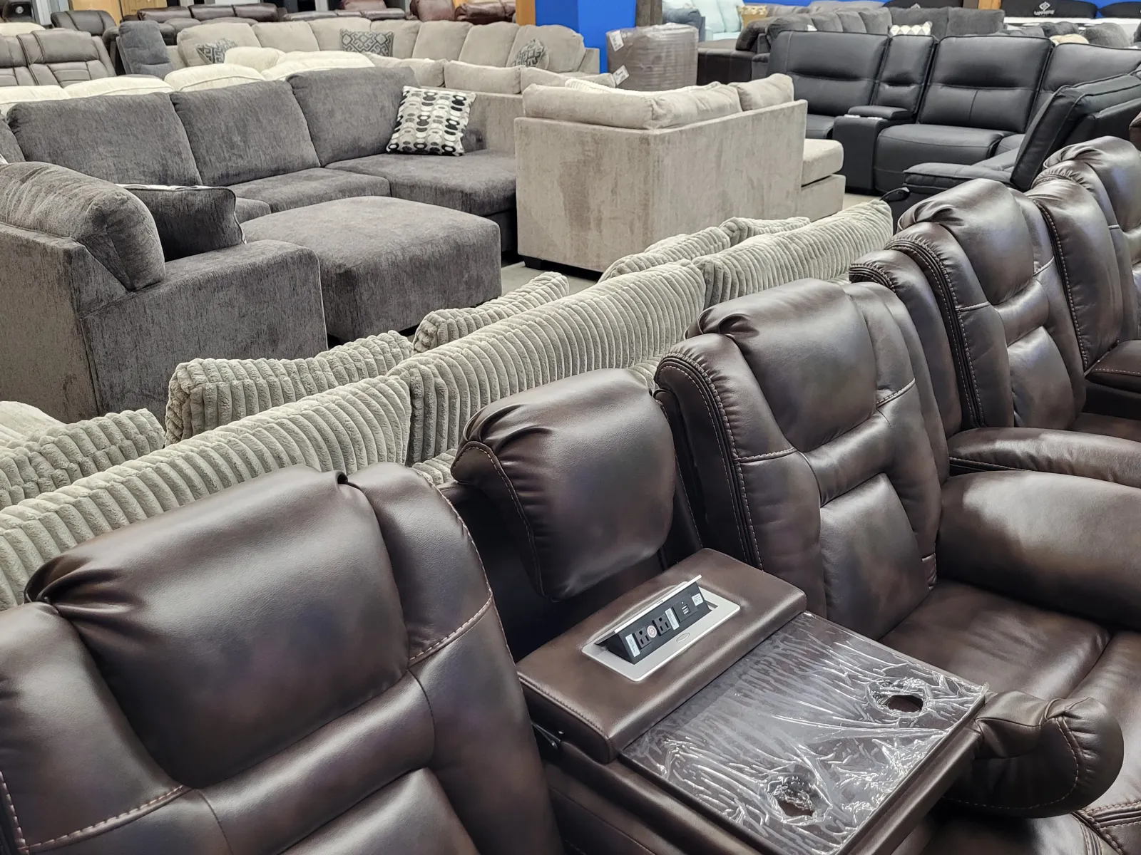 a large group of grey leather couches