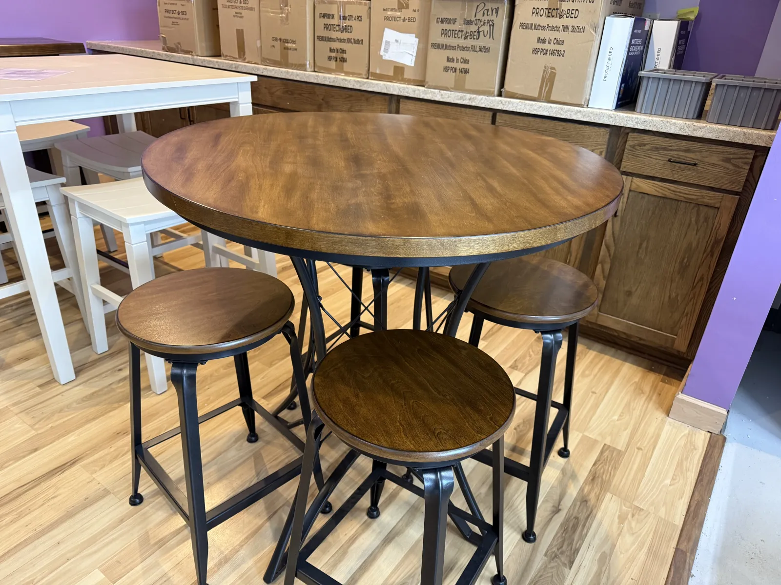 a group of stools in a room with boxes on the wall