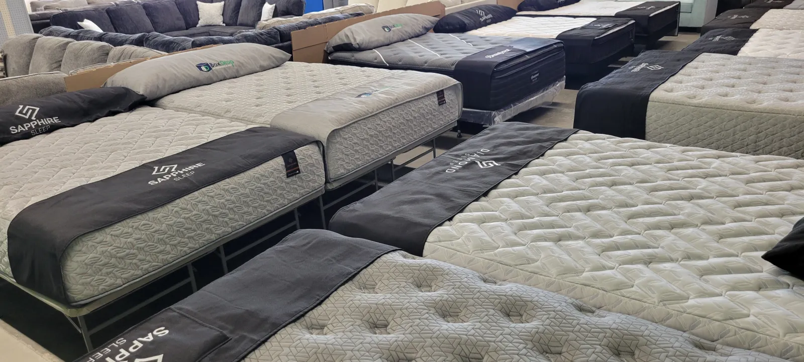 a group of beds with white sheets