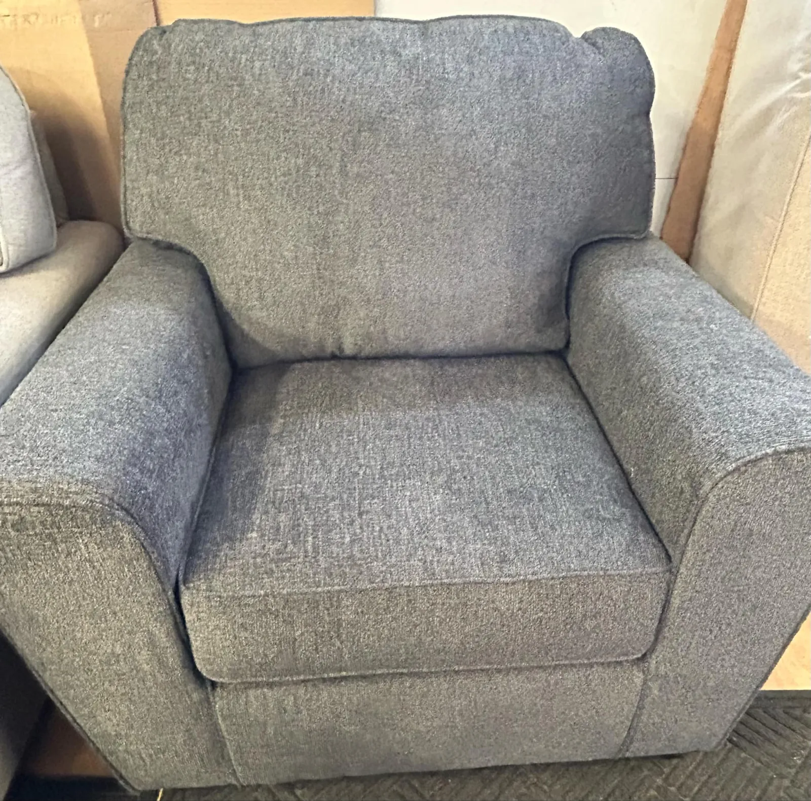 a grey chair with a cushion