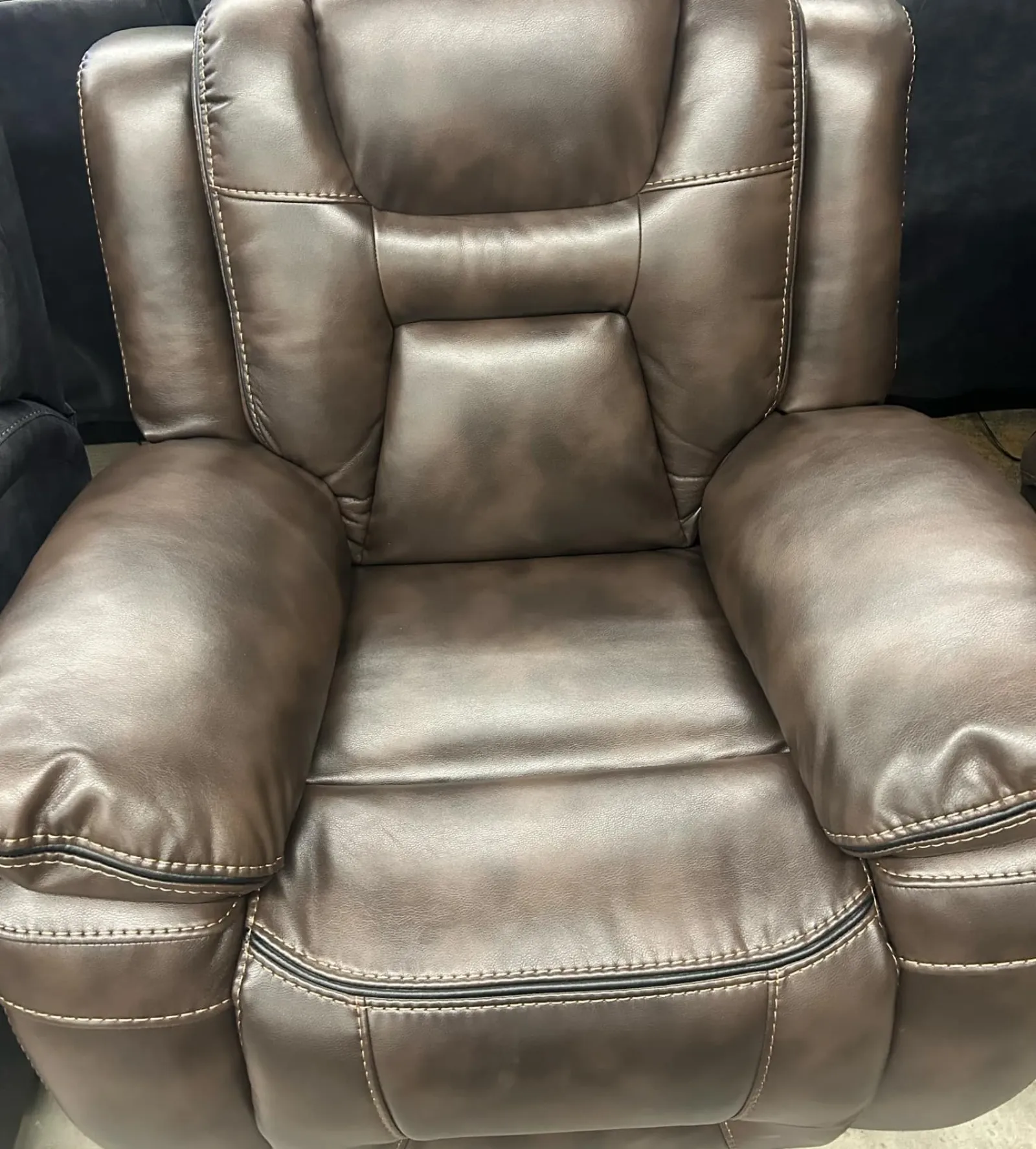 a leather chair with a leather arm rest