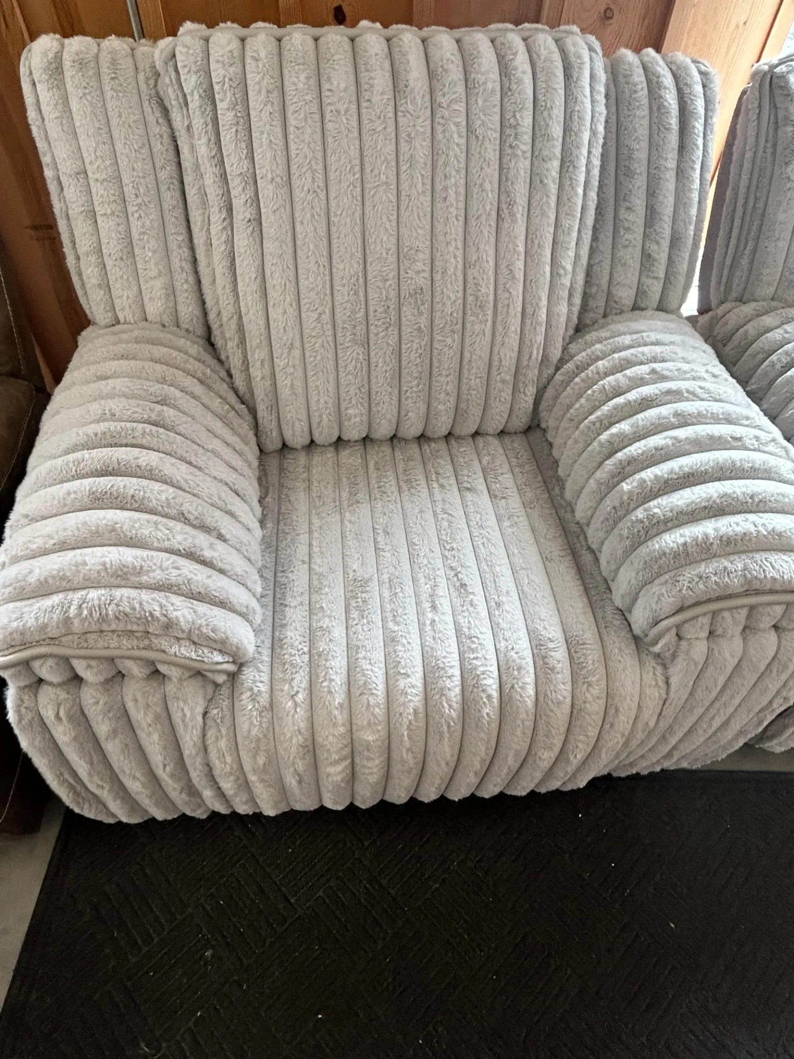 a grey couch with a cushion