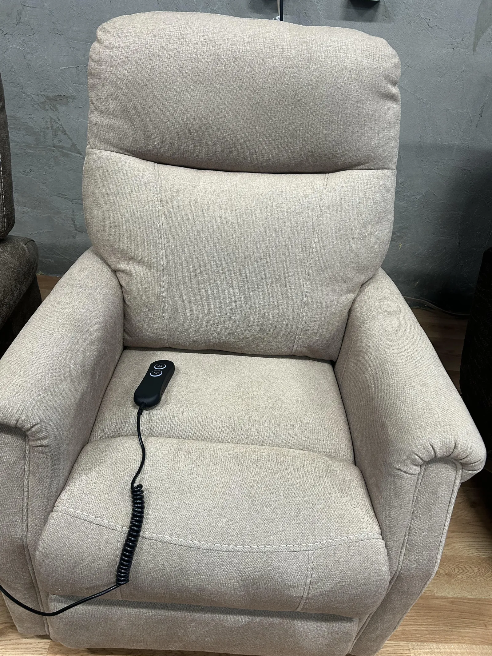 a grey chair with a black cord