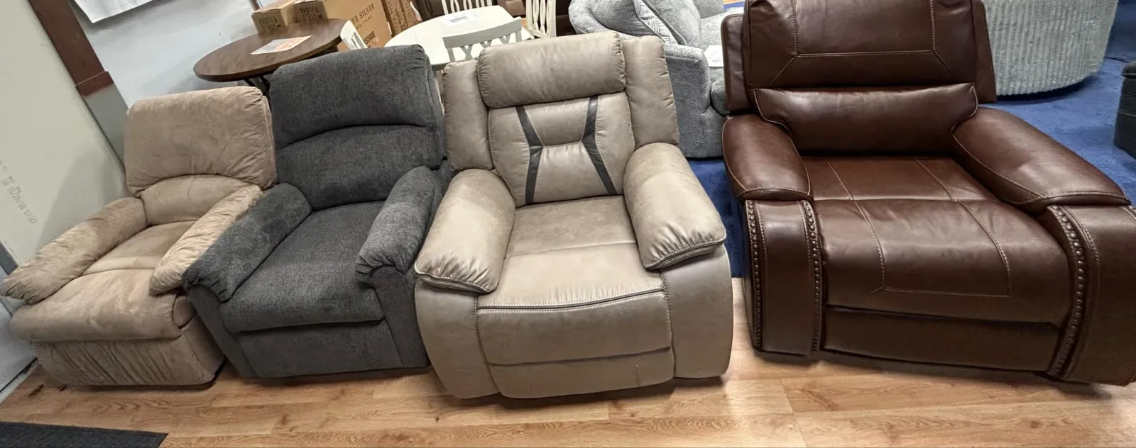 a group of brown leather couches