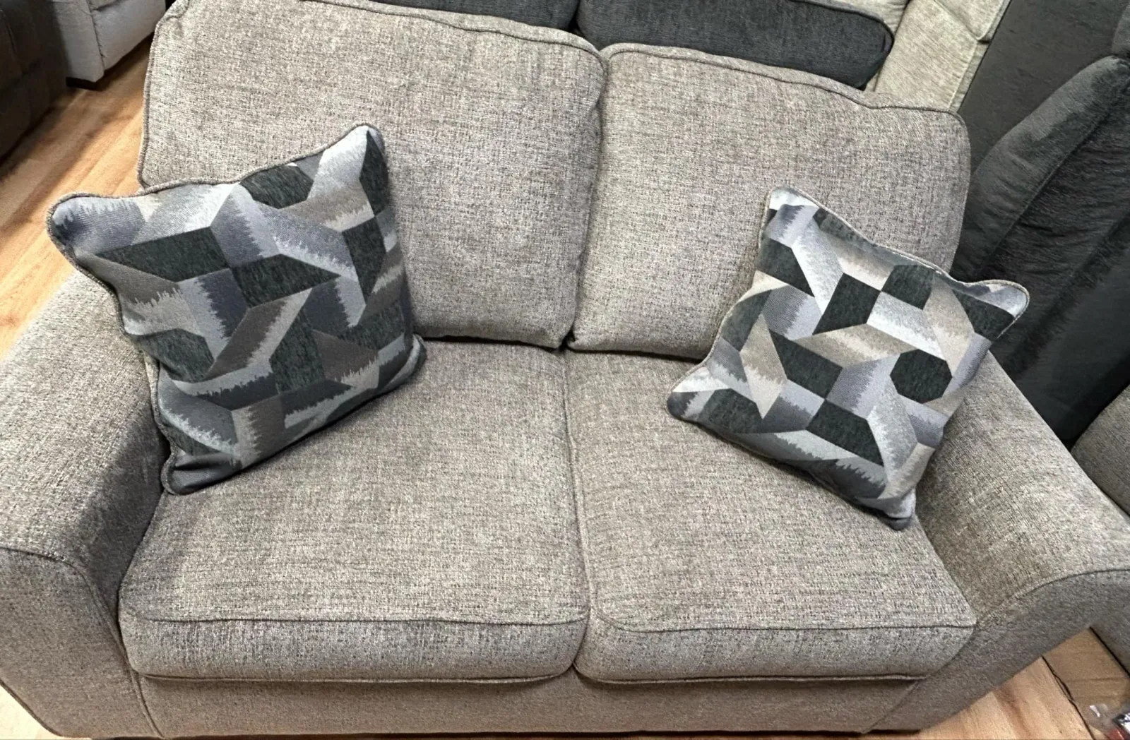 a pair of grey and white socks on a grey couch