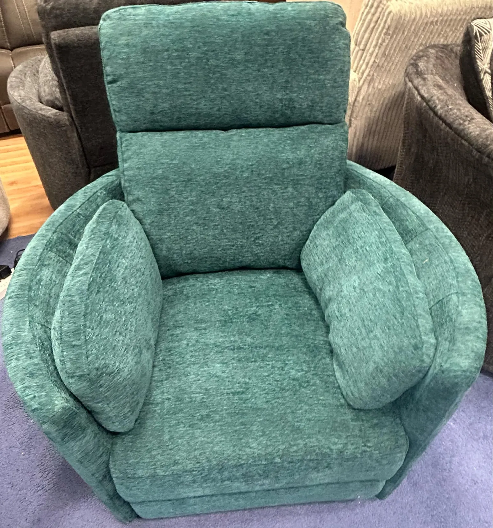 a green couch with a cushion