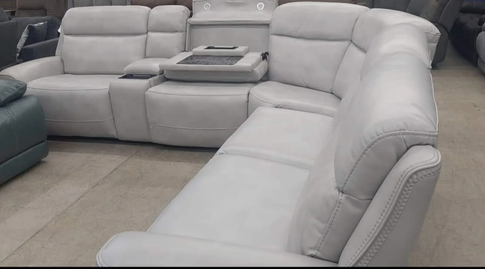 a white couch with a grey cushion