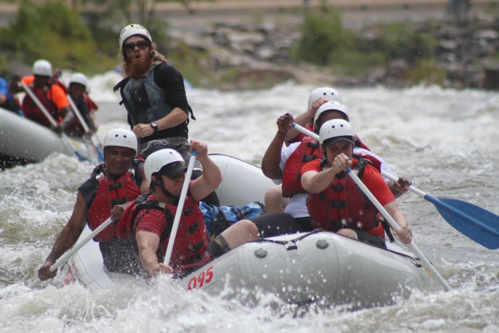 a group of people riding on a raft in a body of water