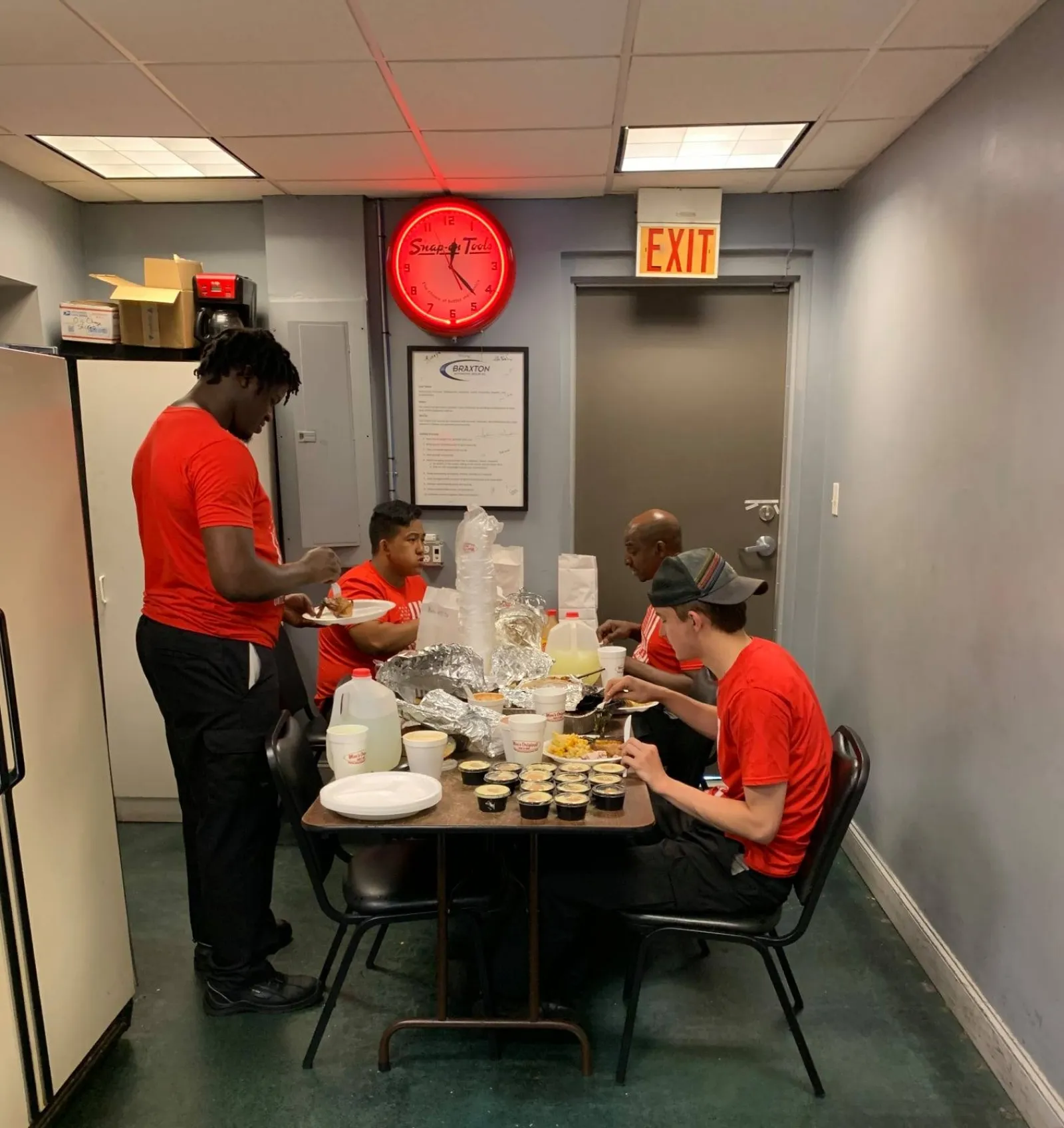 a group of people standing in a kitchen