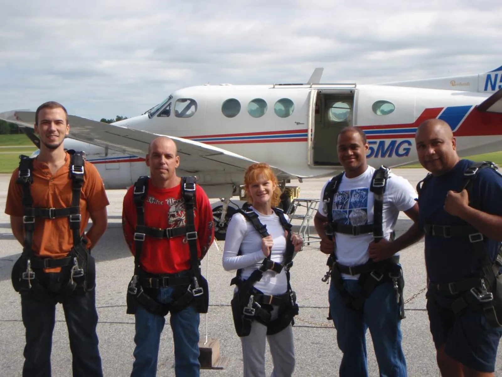 a group of people standing around a plane