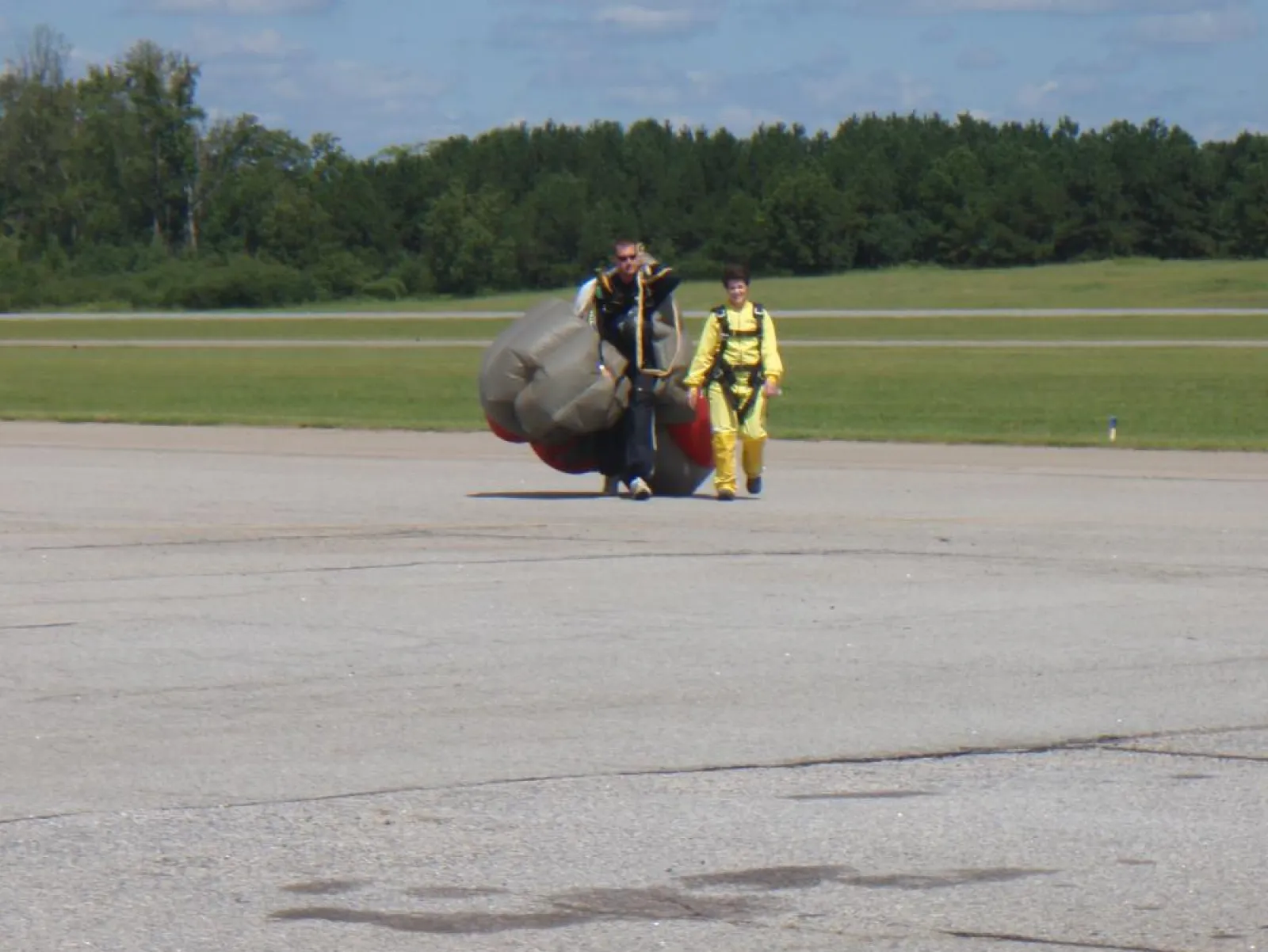 two people walking back from sky diving