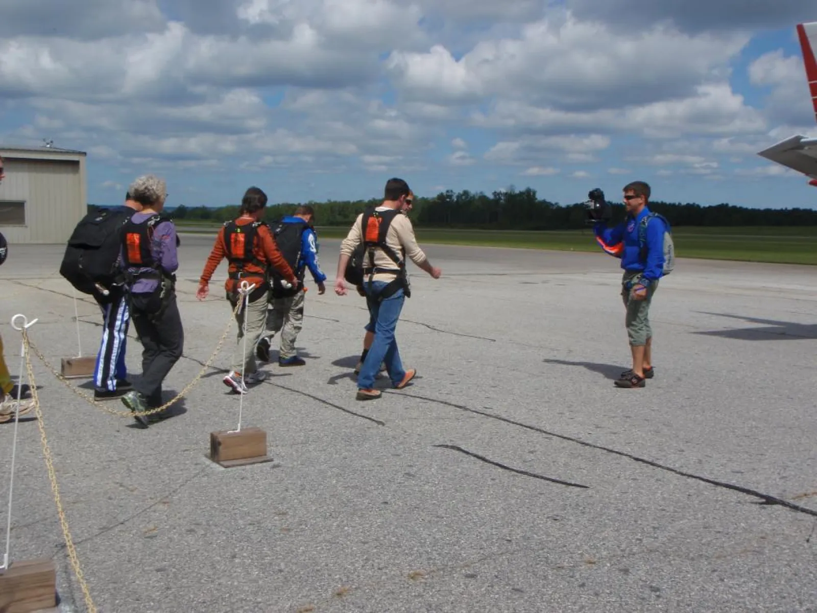 a group of people standing on a runway