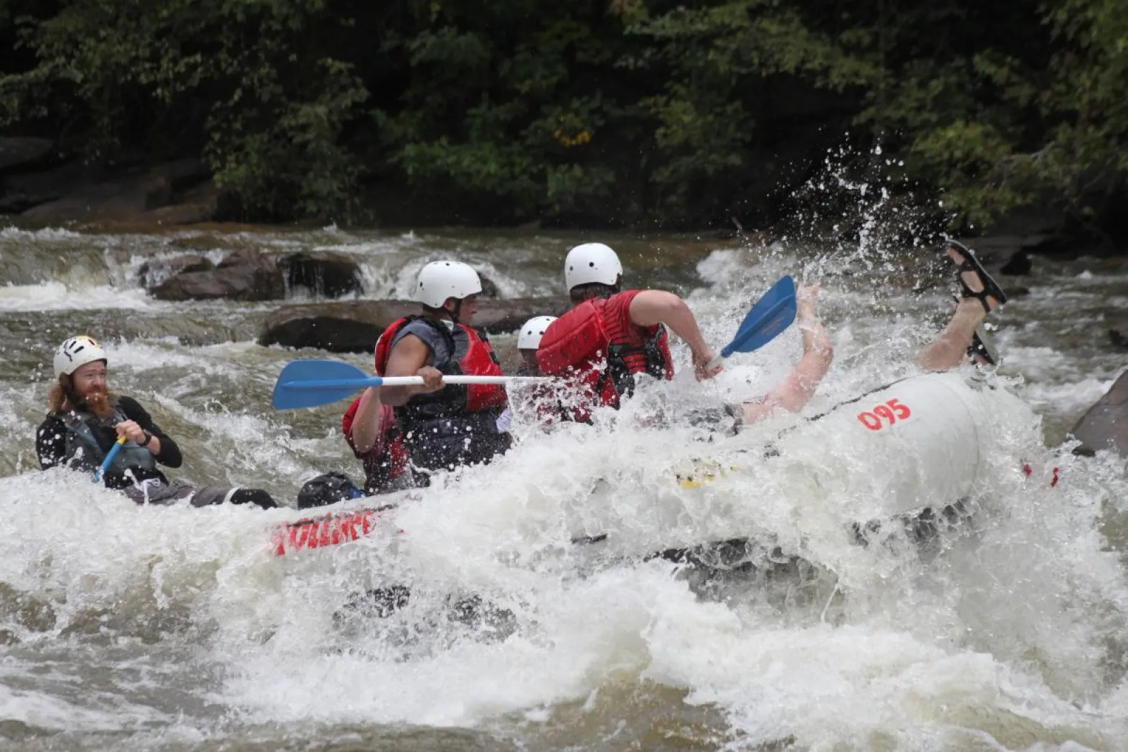 a group of people riding on a raft in a body of water