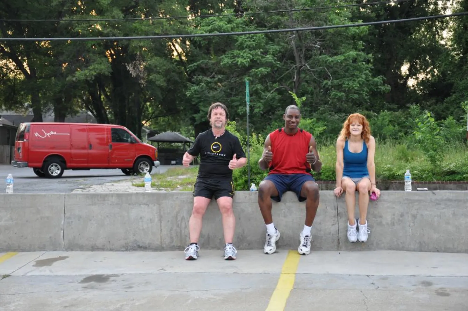 a group of people sitting in a parking lot