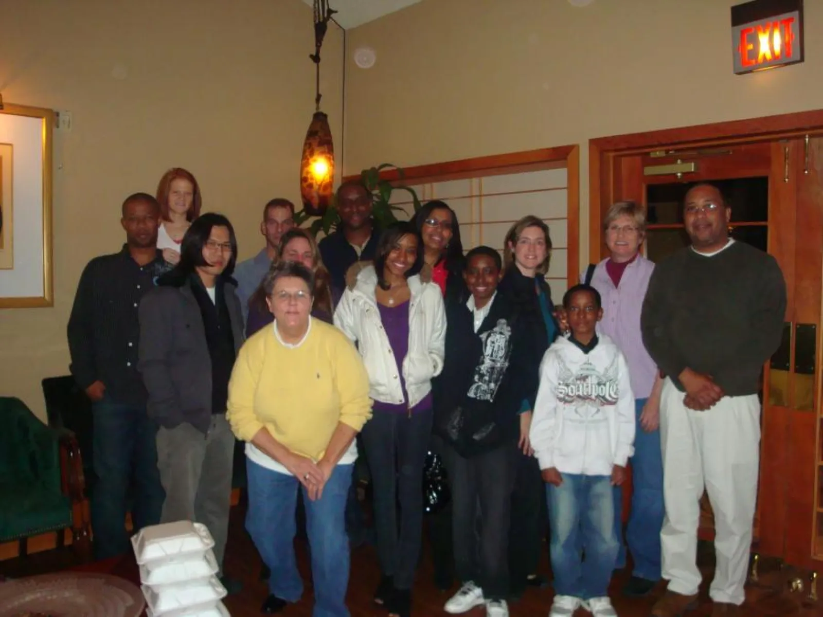 a group of people standing in front of a crowd posing for the camera