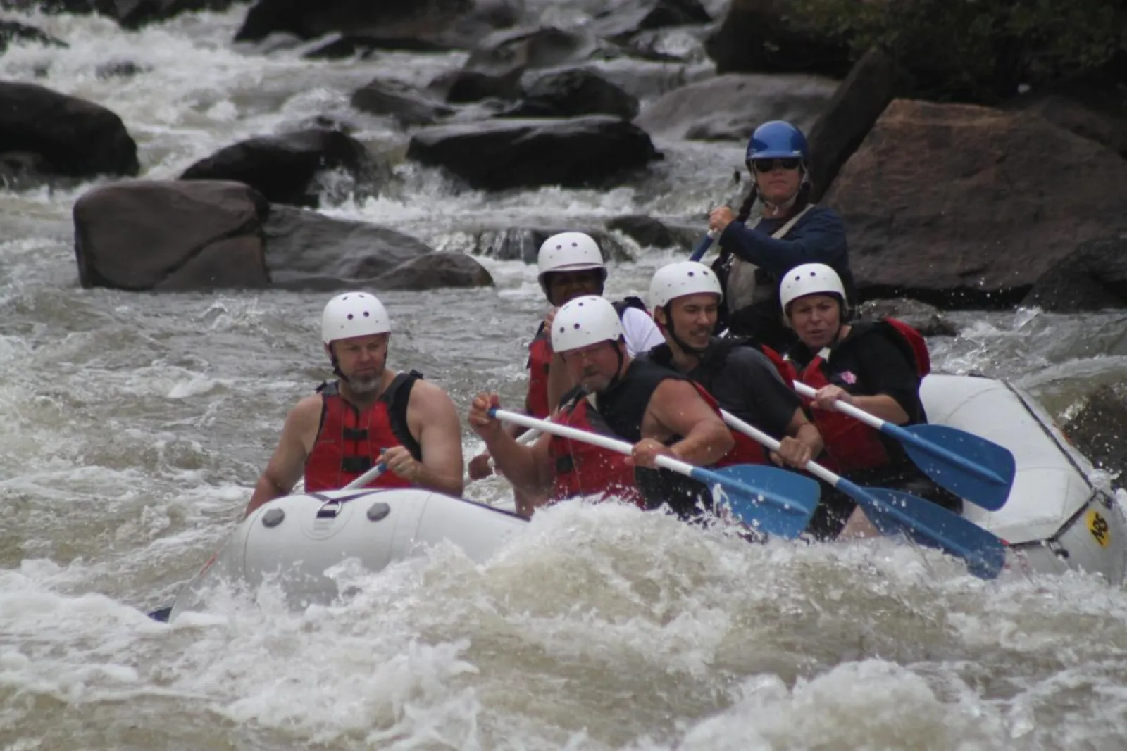 a group of people on a raft in a body of water