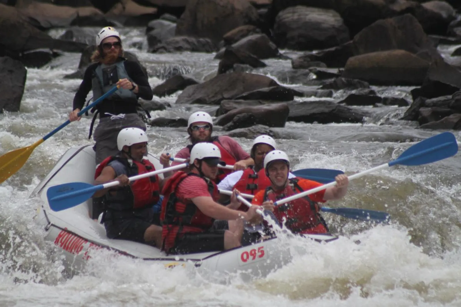 a group of people riding on a raft in a body of water