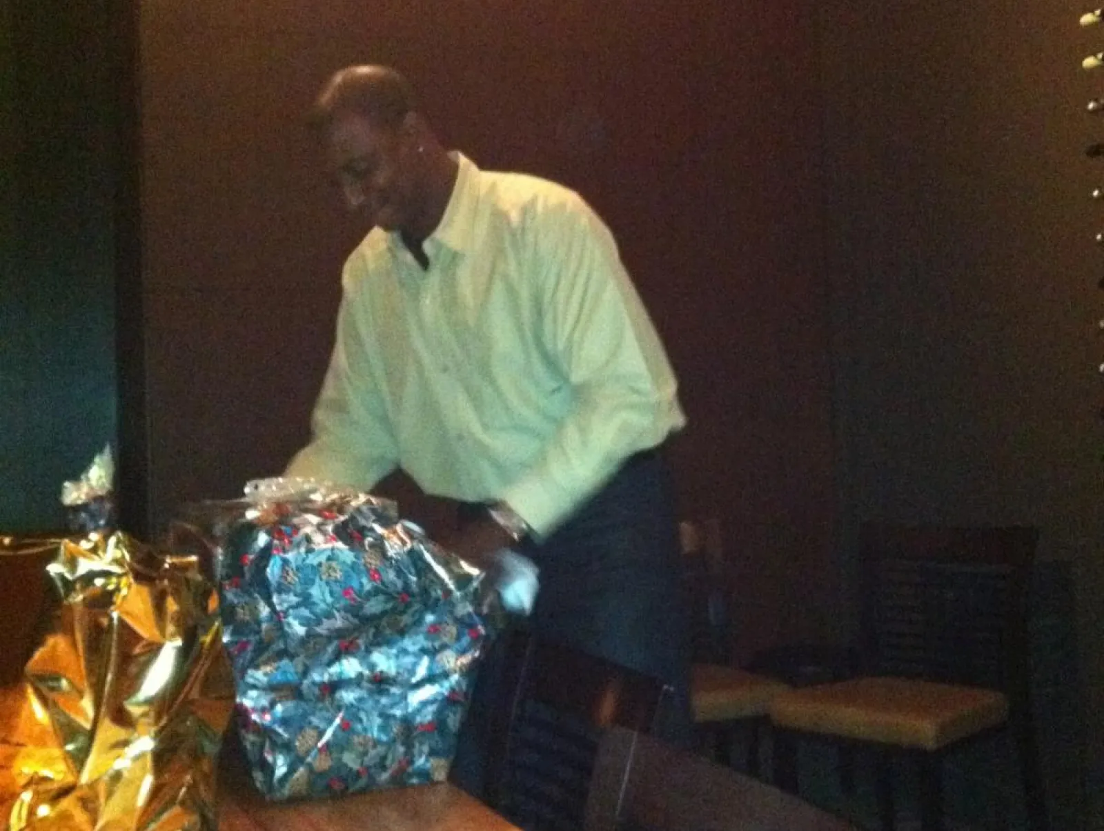 a man by a table with a gift