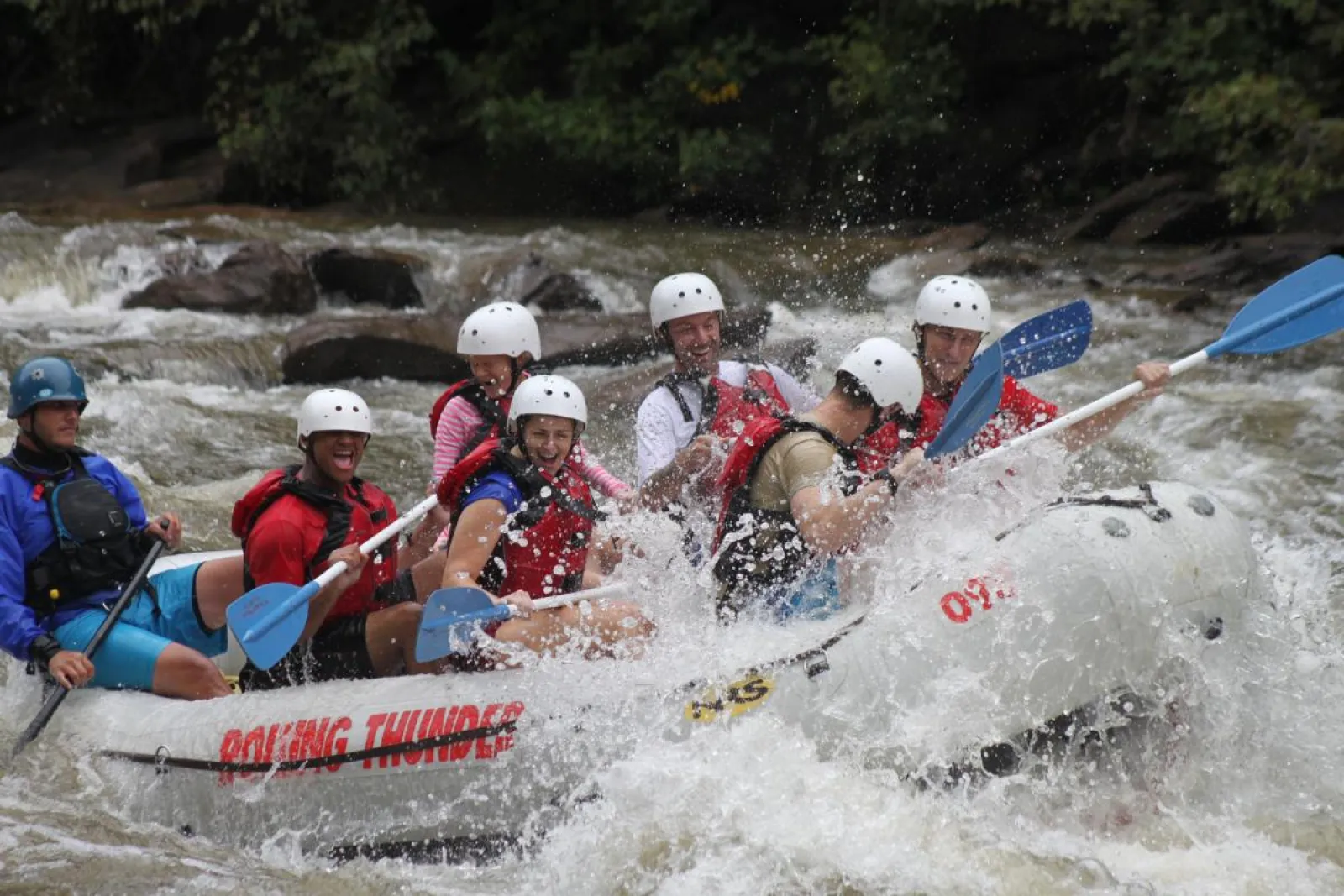 a group of people riding on a raft