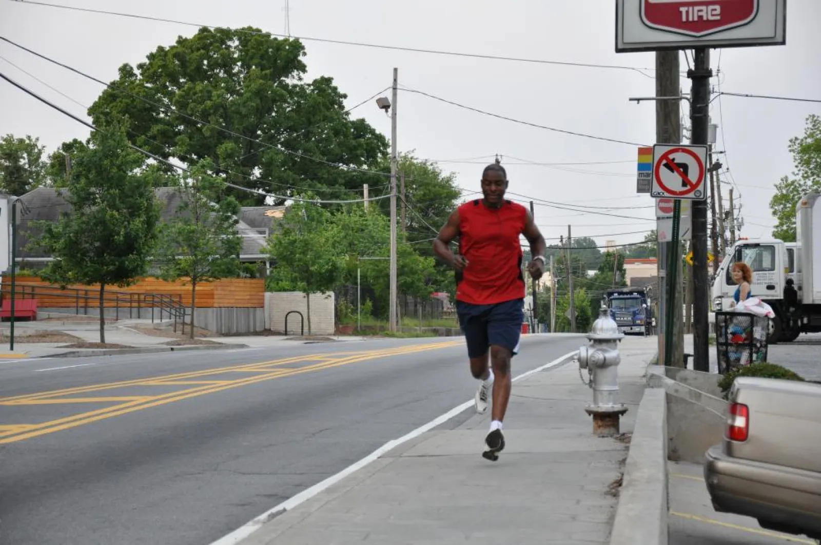 Eric running on the sidewalk