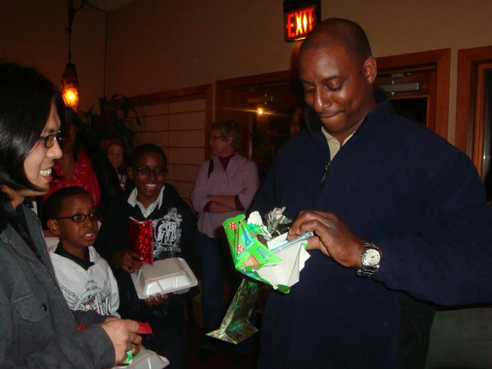 a group of people opening presents