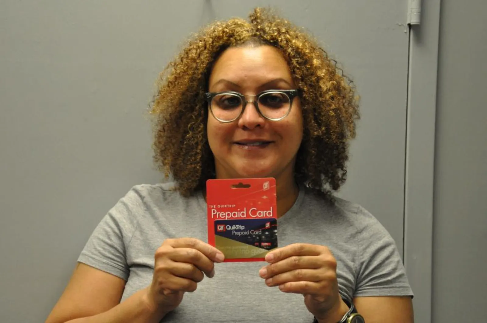 a woman holding a gift card