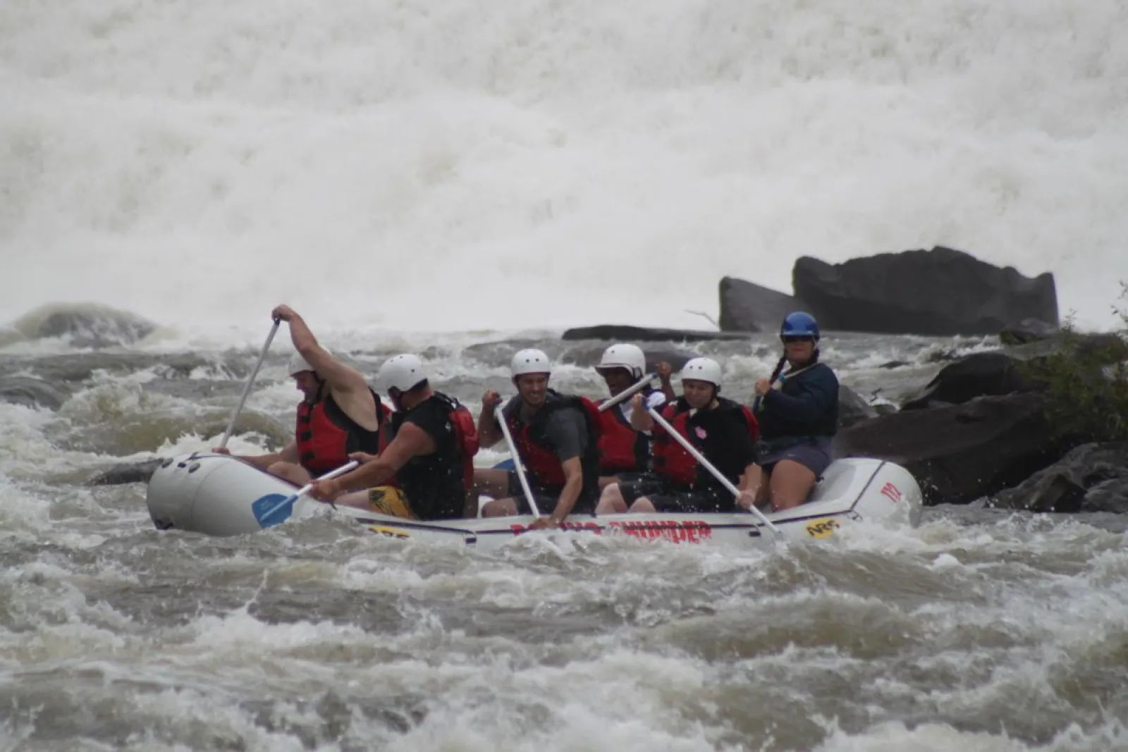 a group of people on a raft in the water