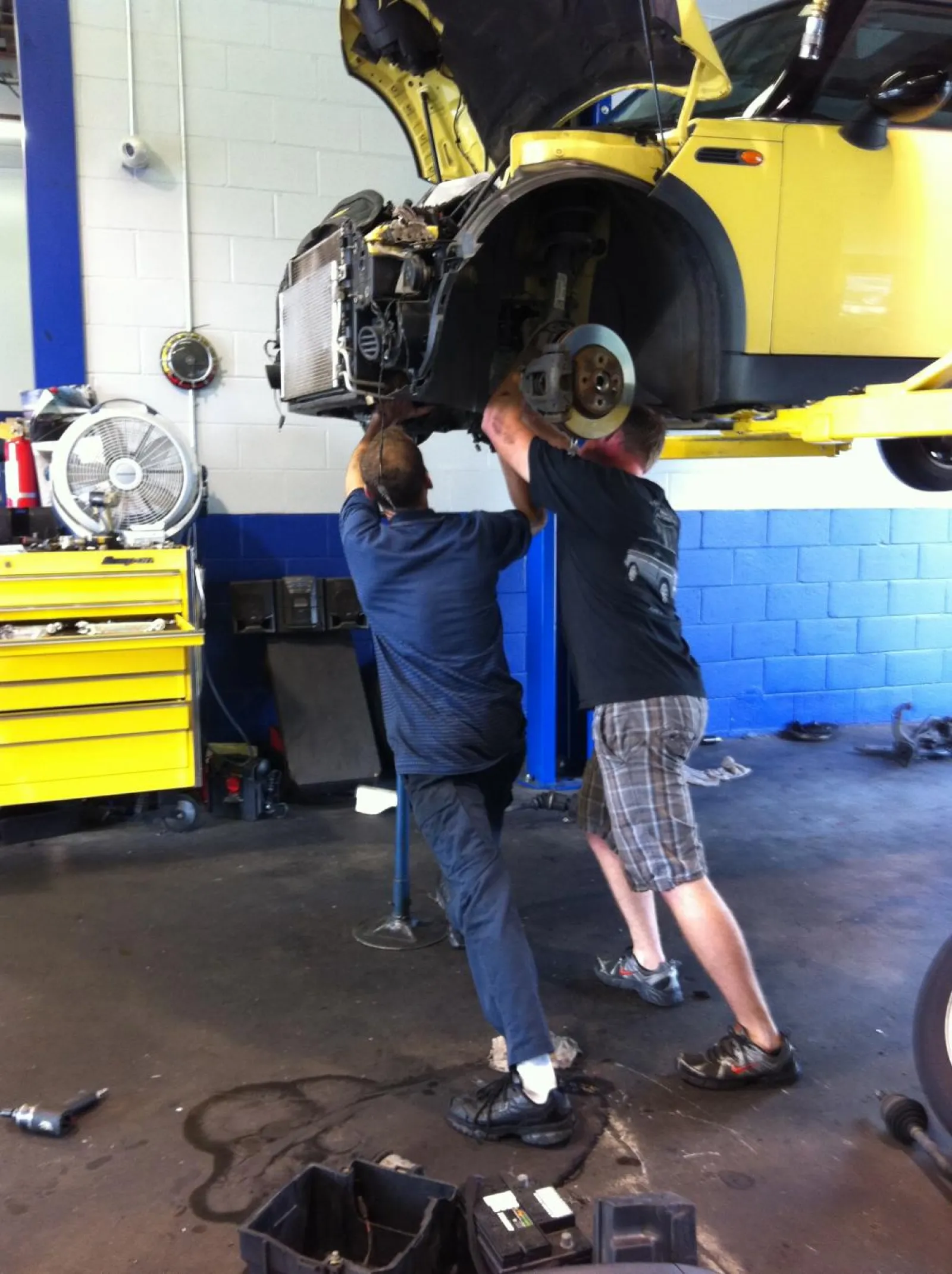 two men working on a car