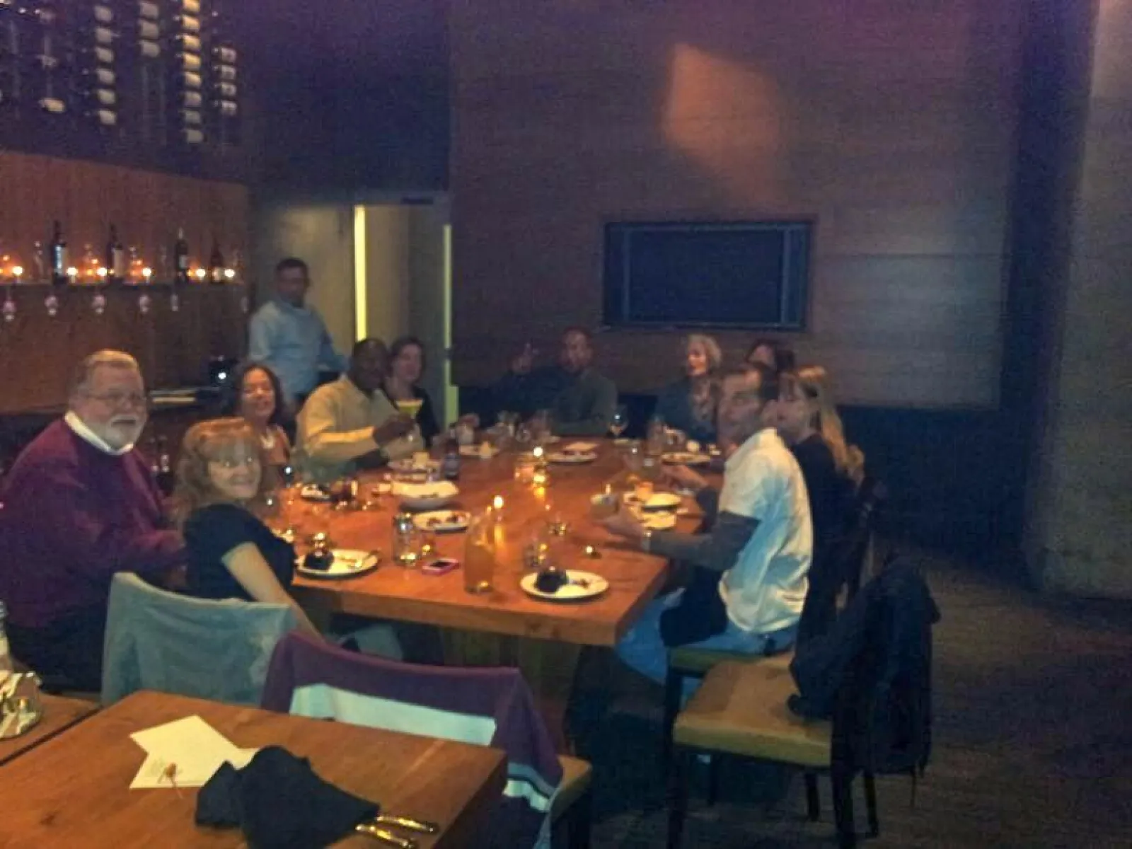 a group of people sitting at a table in a restaurant