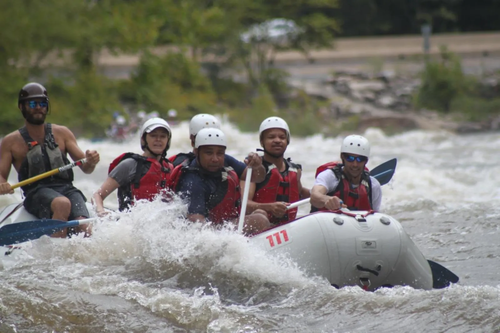 a group of people riding on a raft in the water