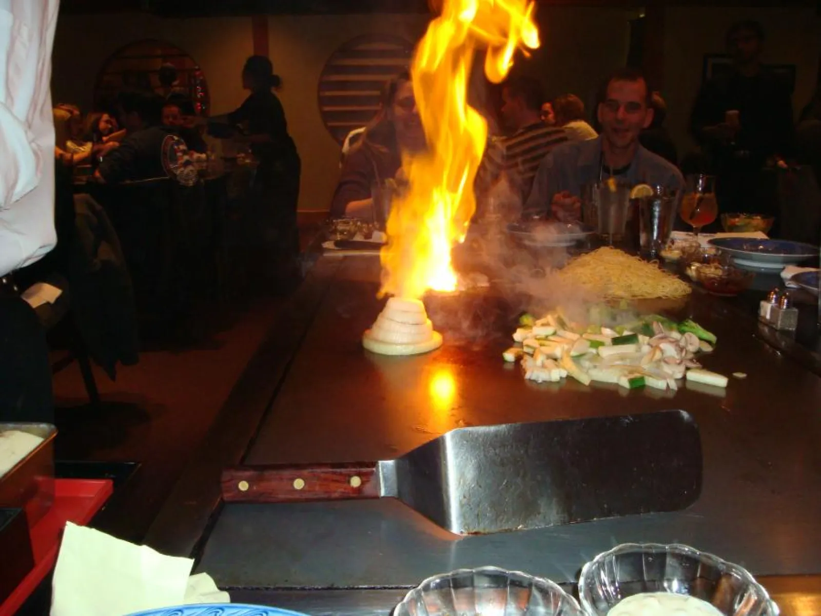 people sitting at a hibachi grill