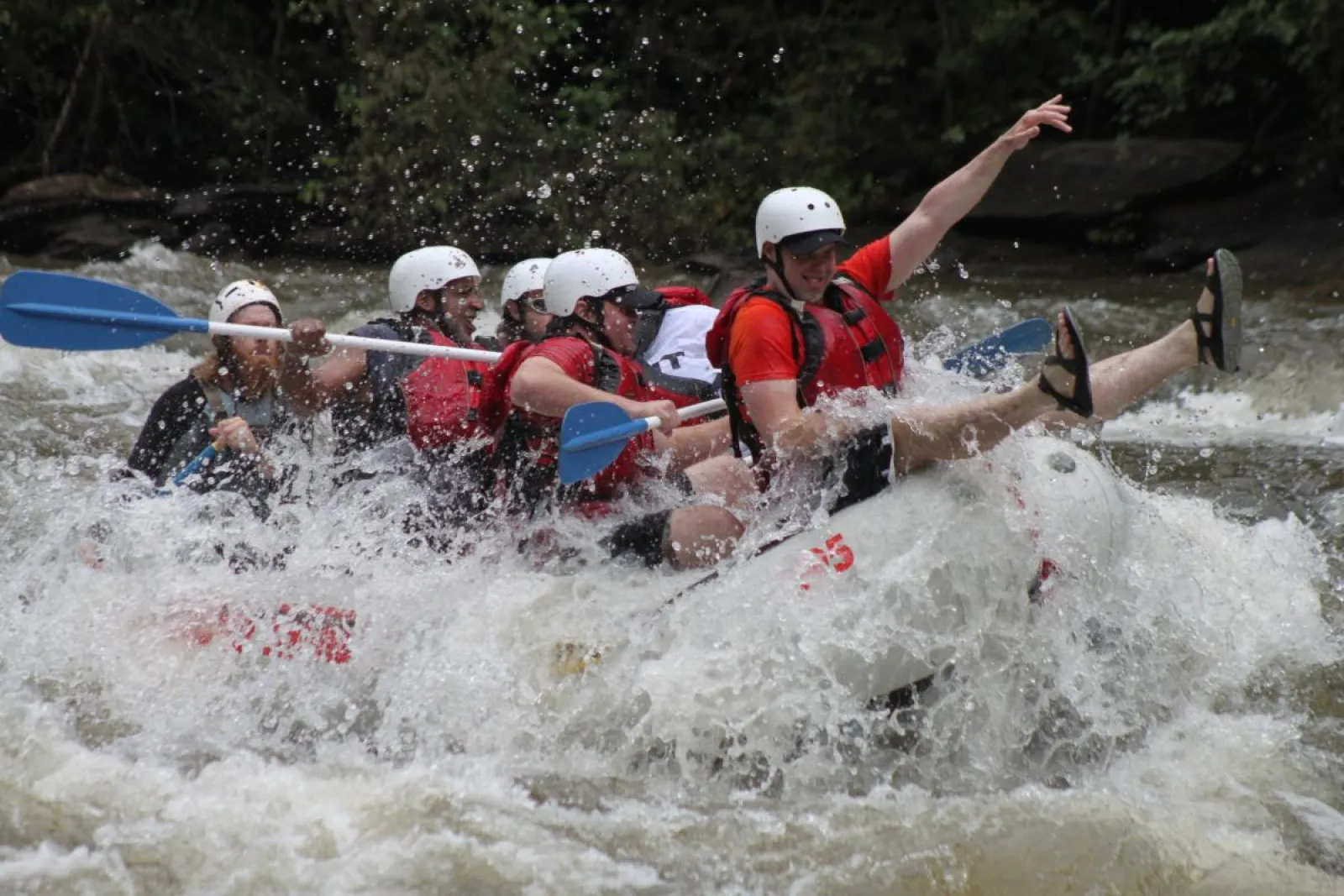 a group of people riding on a raft in a body of water