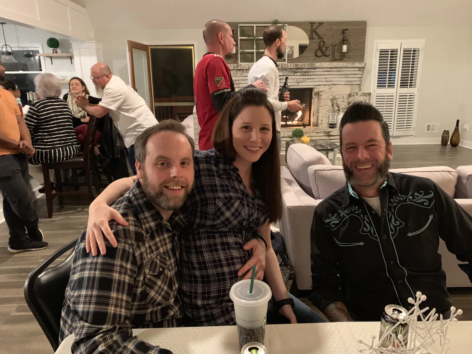 a group of people sitting at a table posing for the camera