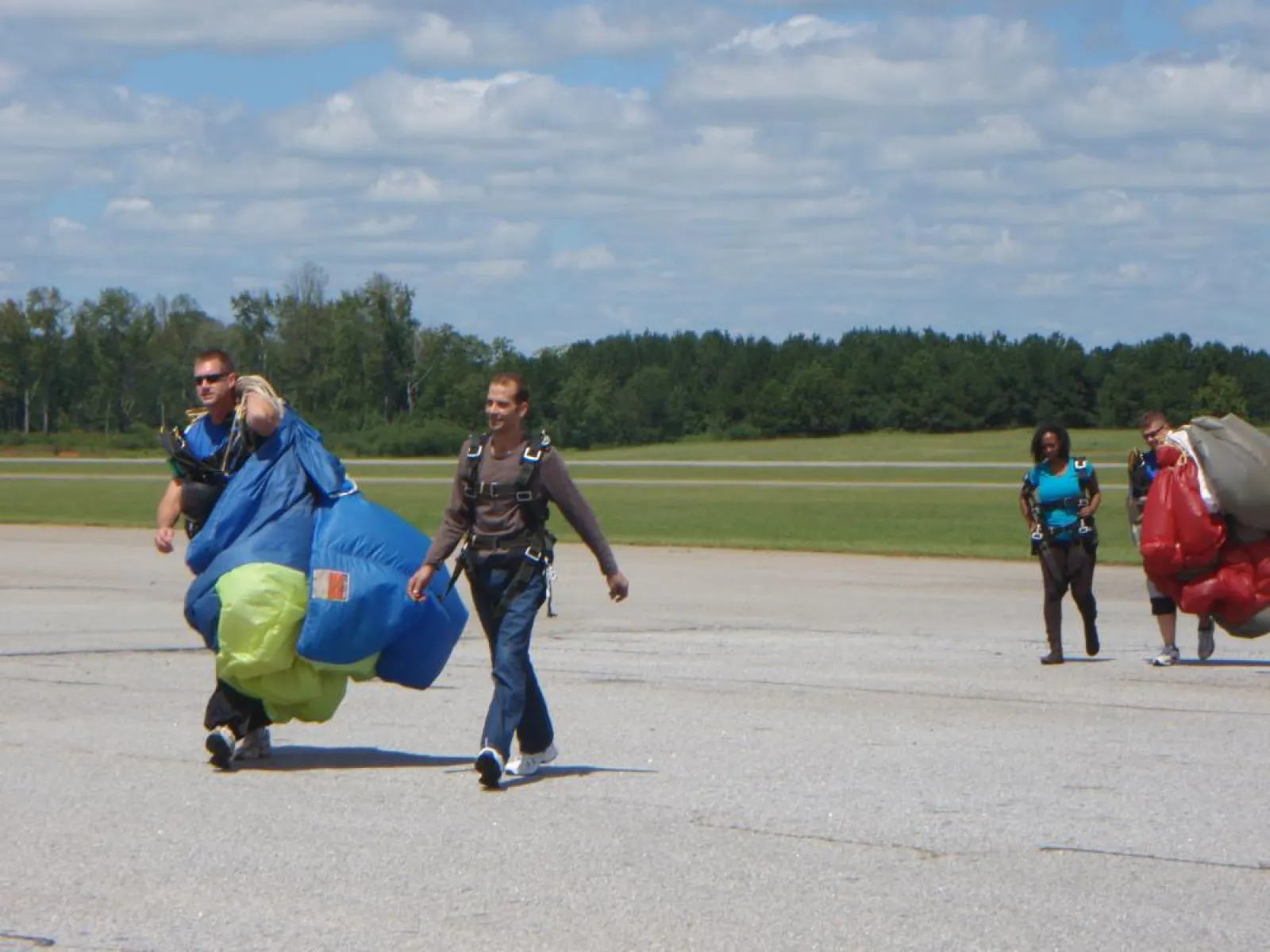 a group of people walking back from sky diving
