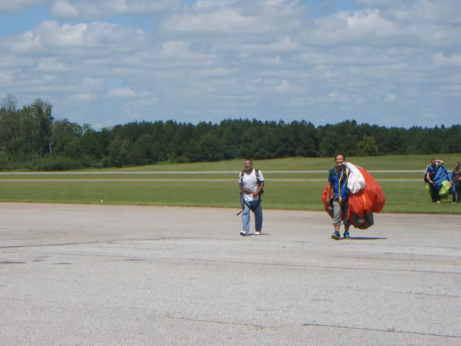 a group of people walking back from sky diving