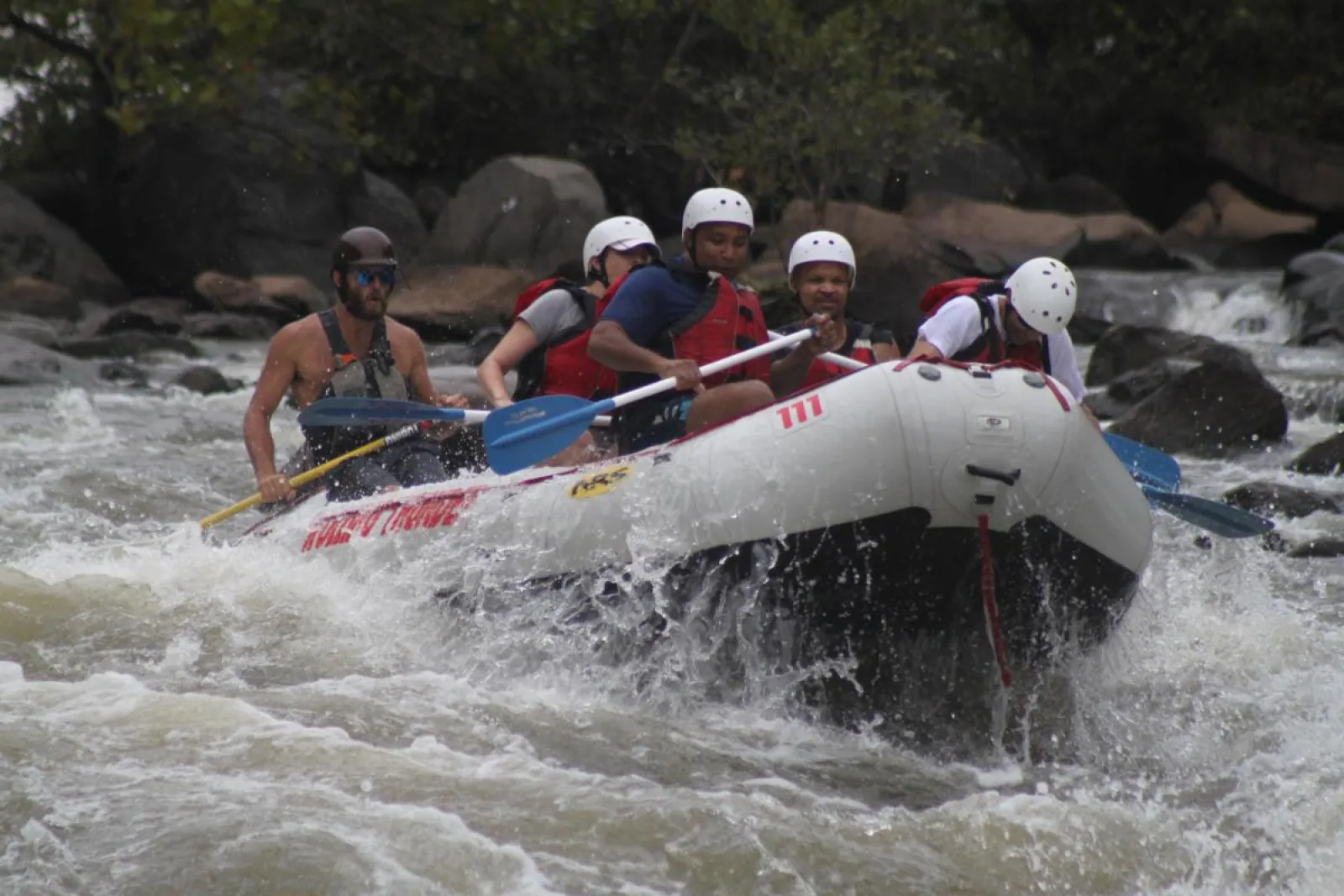 a group of people riding a river raft
