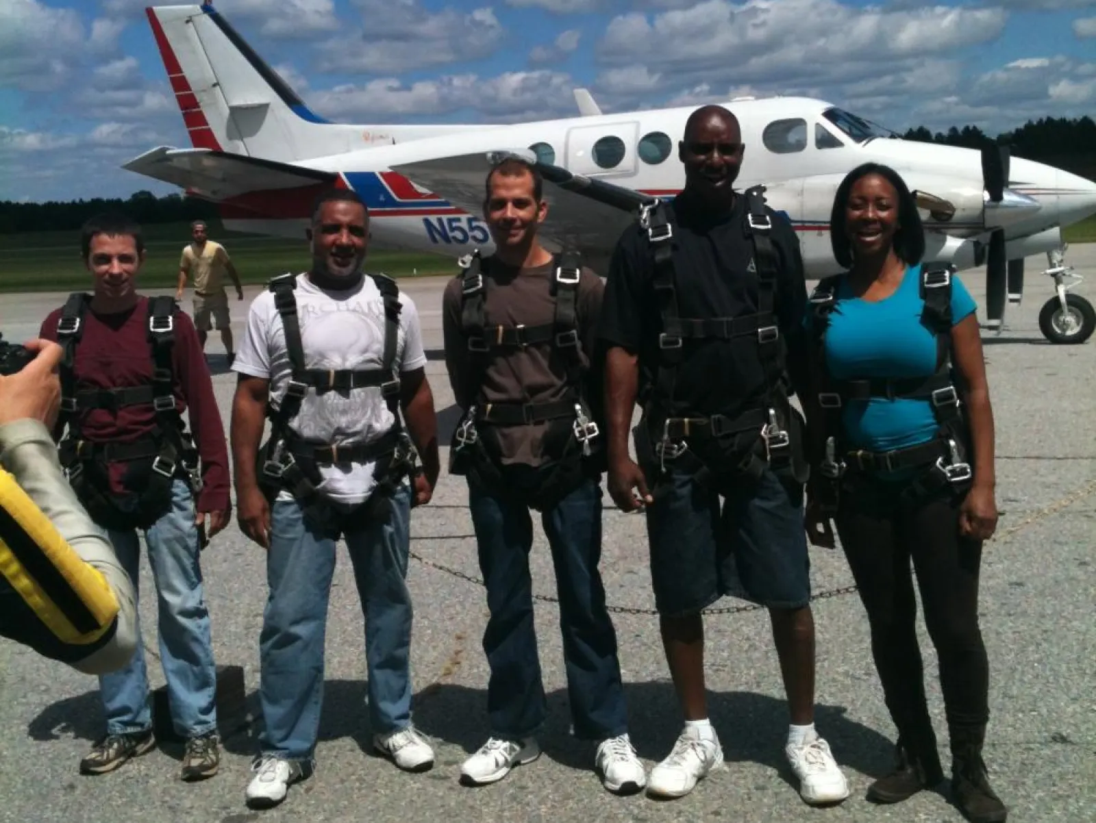 a group of people standing around a plane