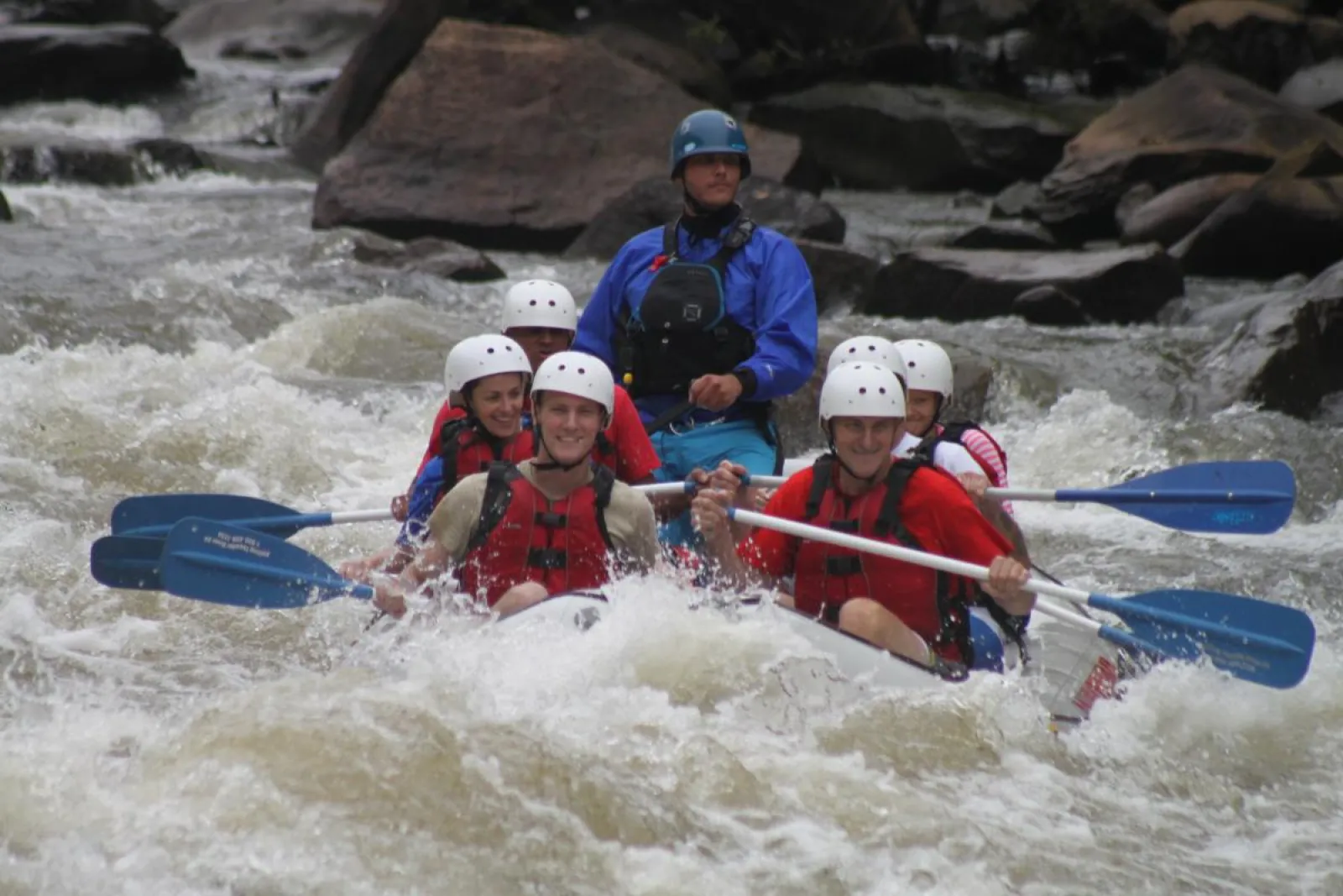 a group of people on a raft in the water