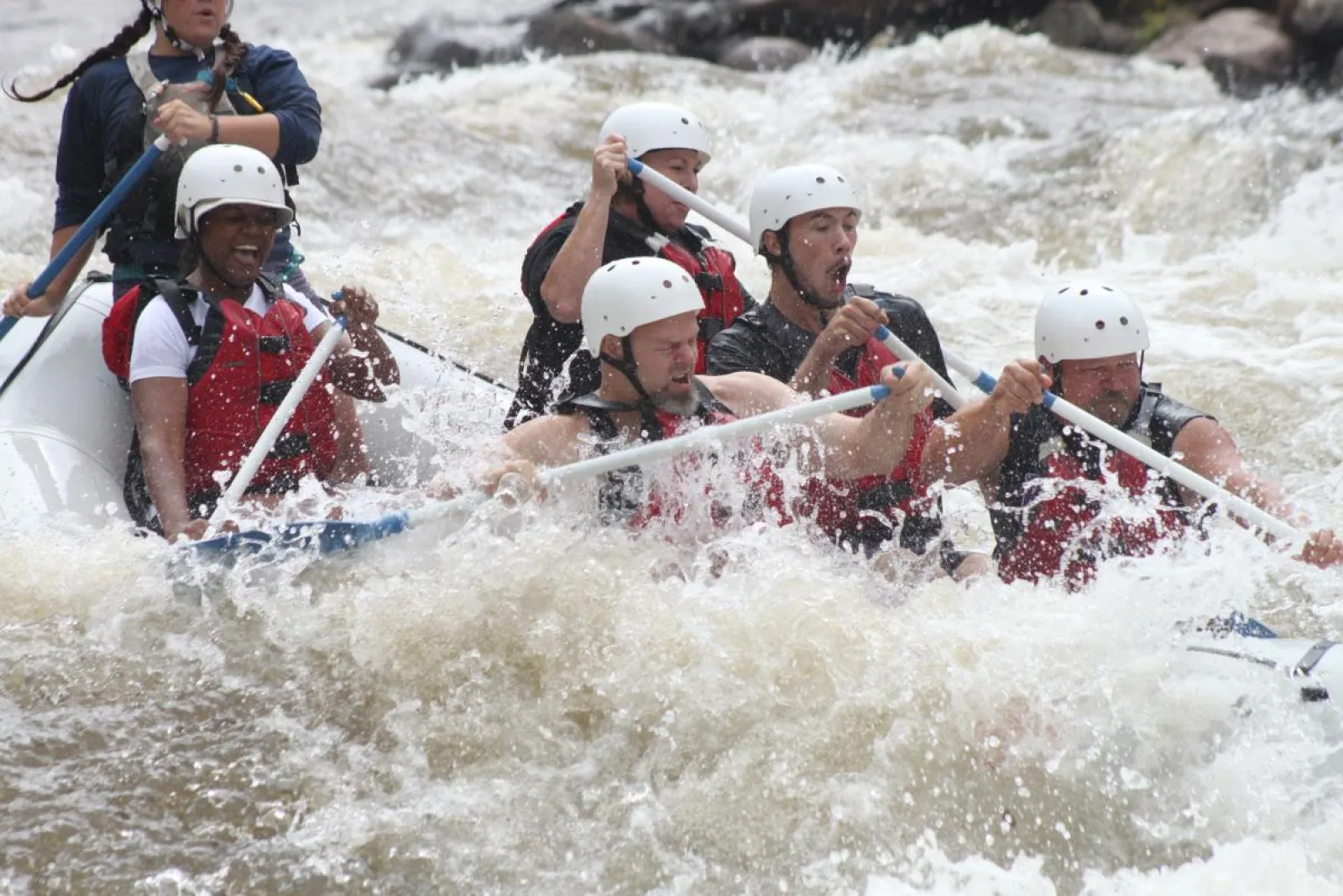 a group of people riding on a raft in a body of water