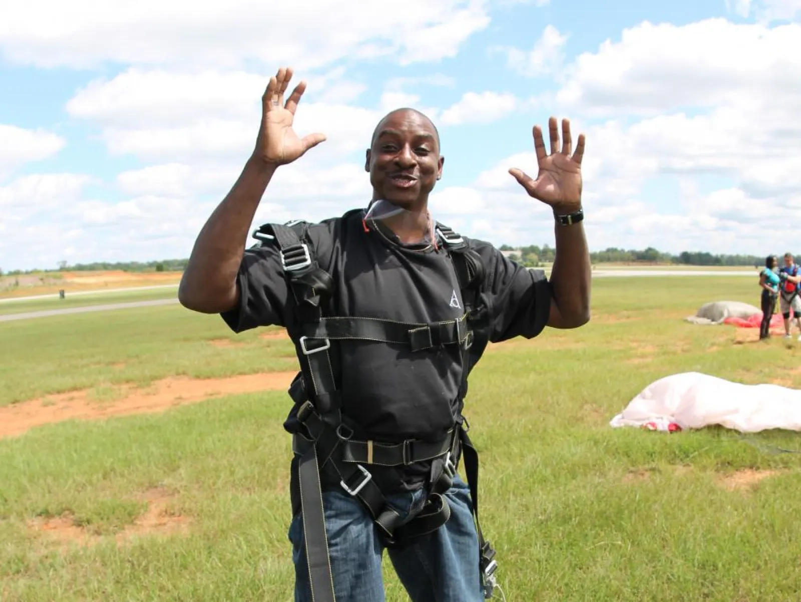 a man standing on top of a grass covered field