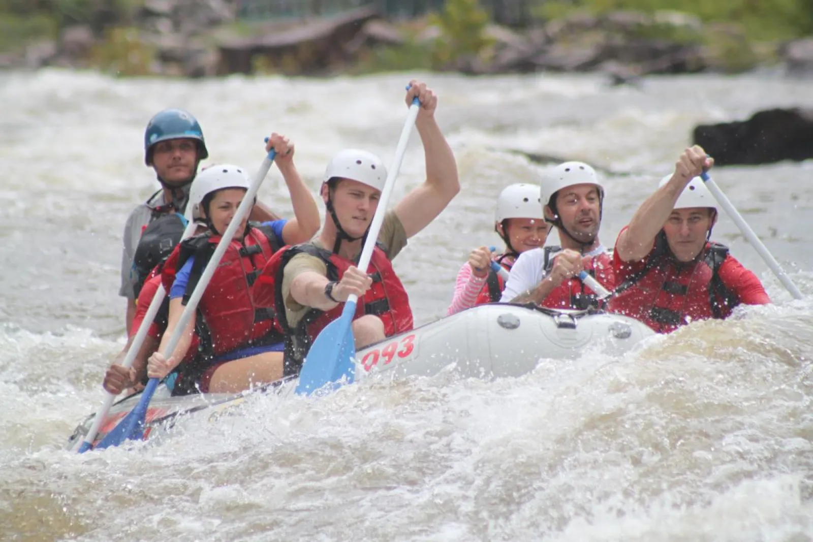 a group of people on a raft in a body of water