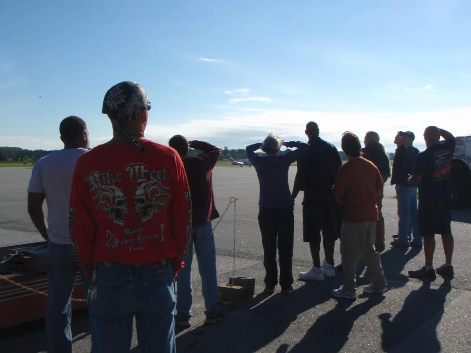 a group of people standing on a runway