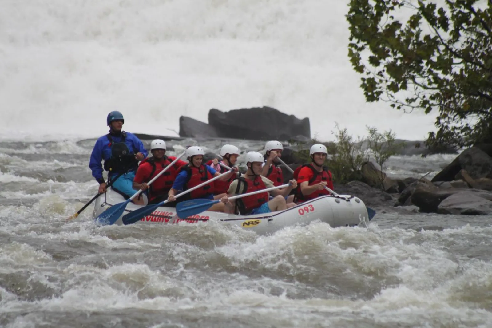 a group of people riding on a raft in a body of water