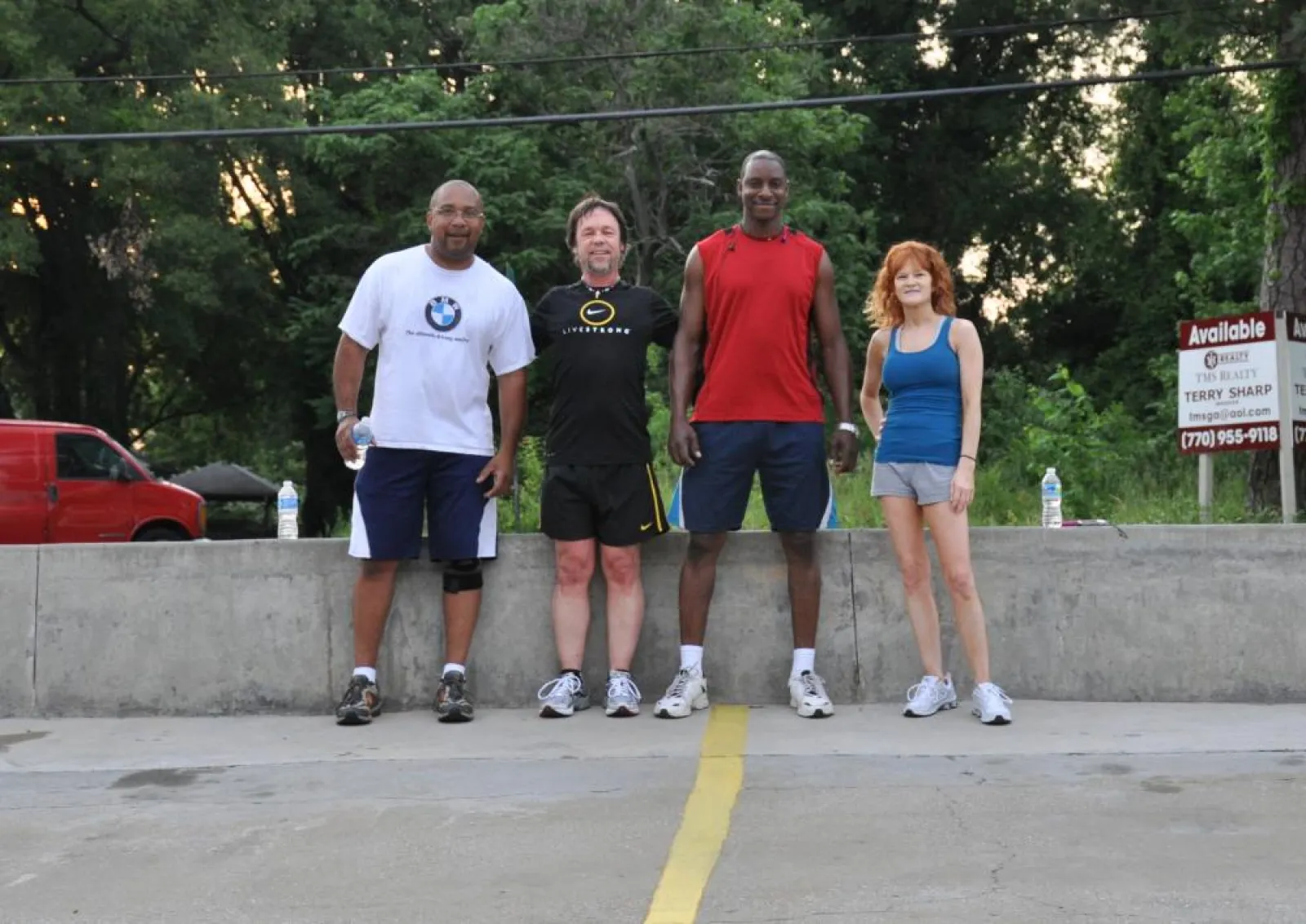 a group of people standing in a parking lot