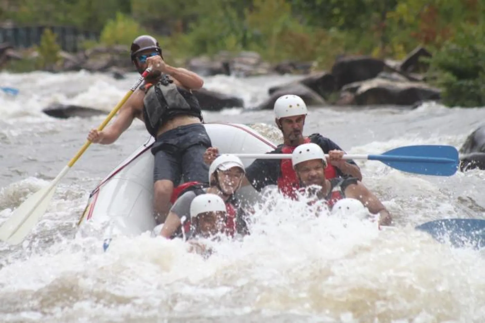 a group of people riding on a raft in a body of water