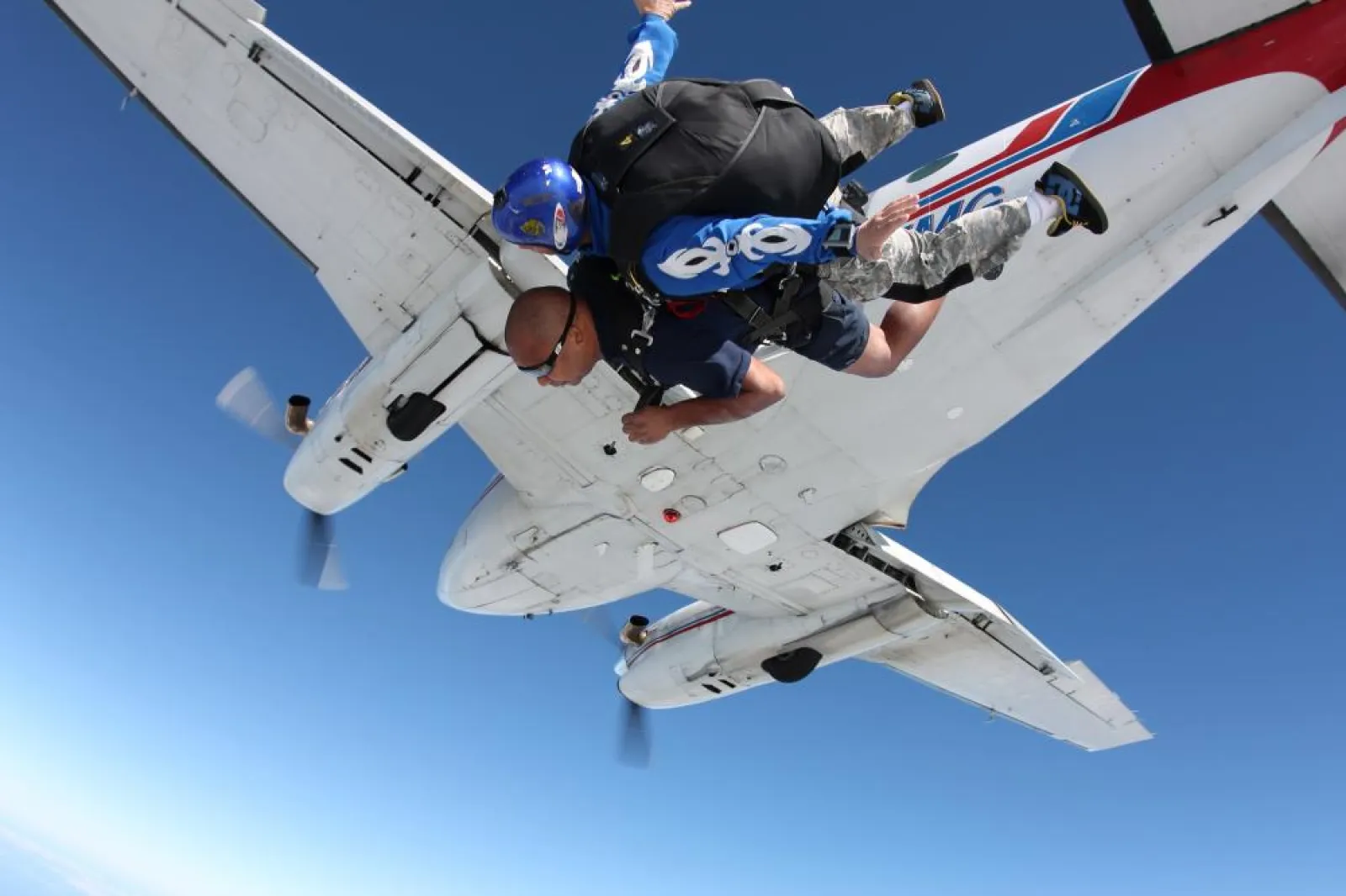 two people jumping out of a plane