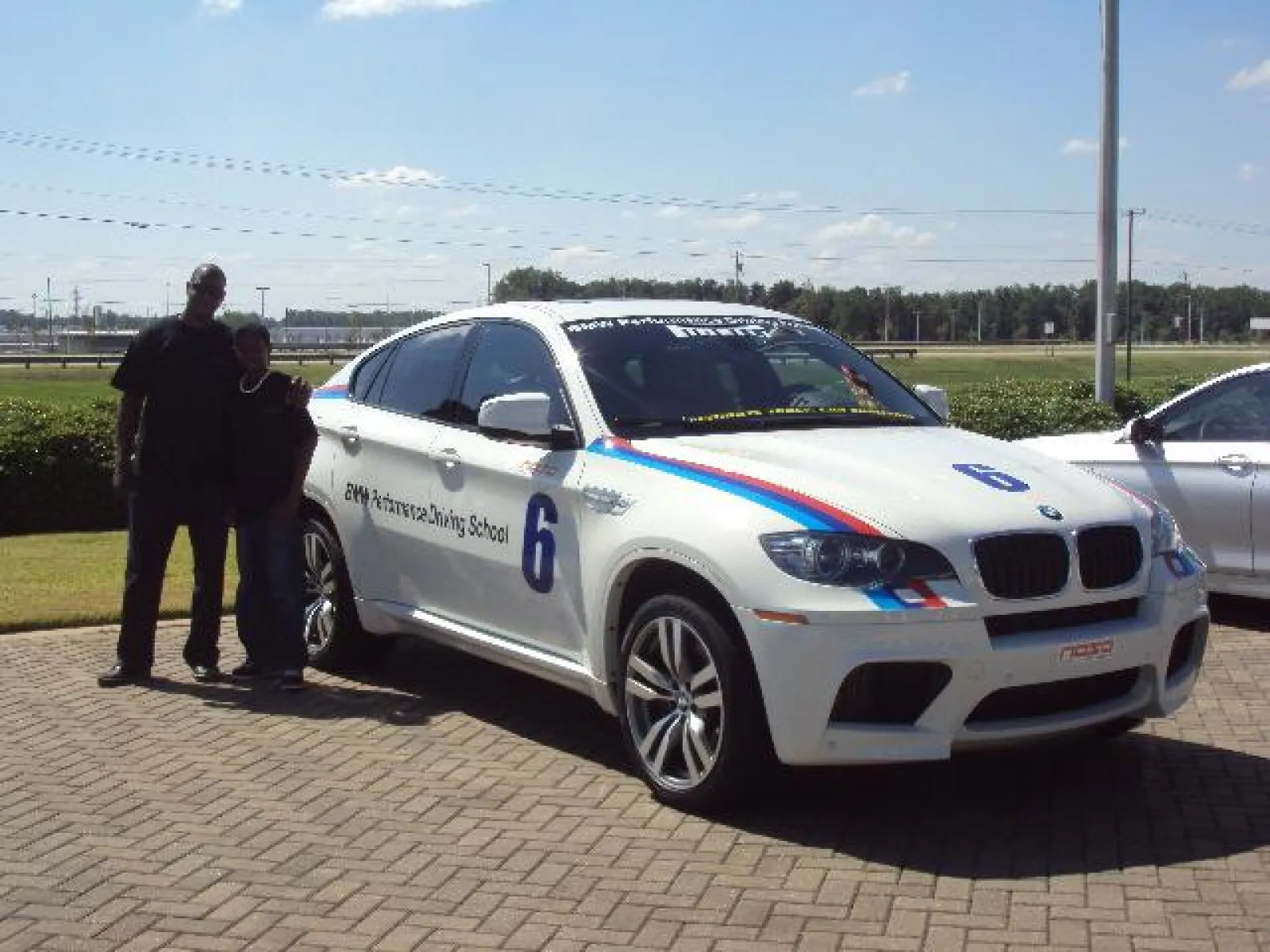 a group of people standing in front of a car