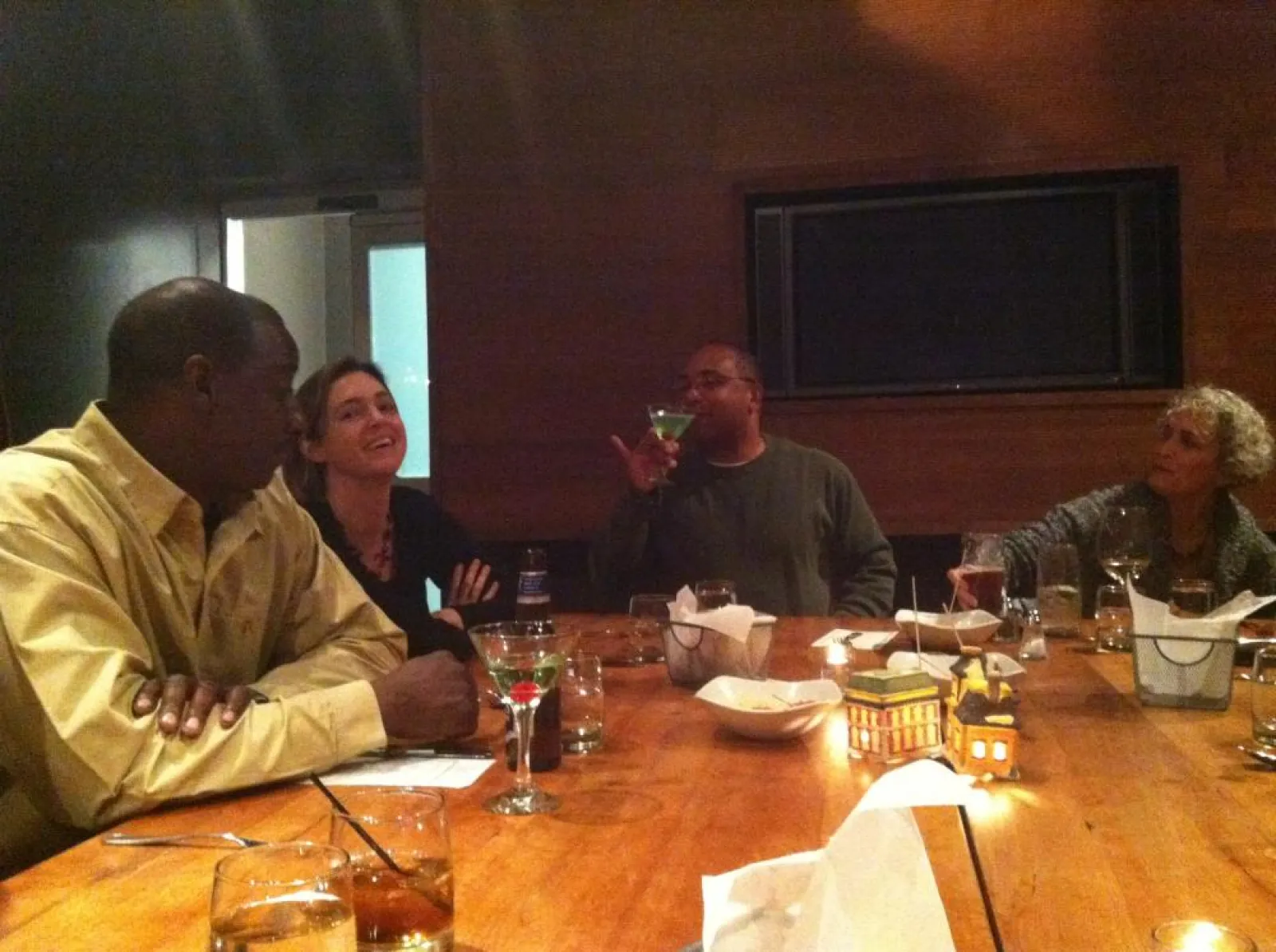 a group of people sitting at a table with wine glasses