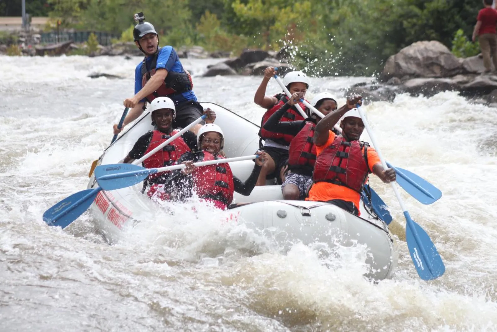 a group of people riding on the rapids